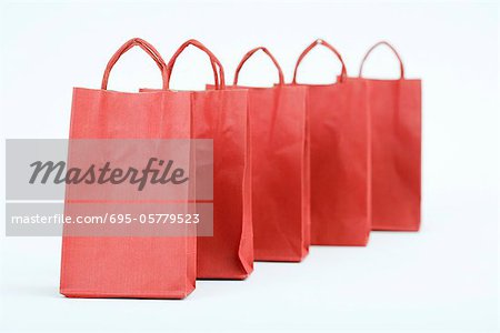 Five red shopping bags lined up