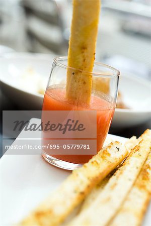 Breadstick dipped in spicy sauce