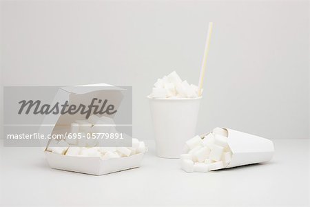 Food concept, sugar cubes inside fast food containers Food concept, sugar cubes inside fast food containers