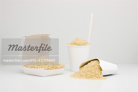 Food concept, uncooked rice inside fast food containers