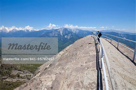 Randonneur touristiques sur Moro rocher surplombant les collines de Sequoia, regardant vers Kings Canyon et les hautes montagnes de la Sierra Nevada, Sequoia National Park, California, États-Unis d'Amérique, Amérique du Nord