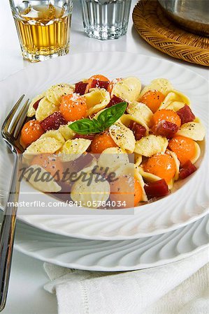 Orecchiette pasta with melon ball, prosciutto (ham), parmesan cheese and basil, Italy, Europe
