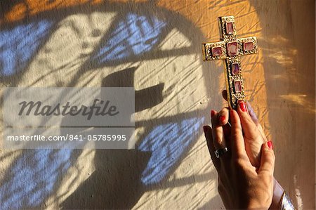Woman holding a cross, Servoz, Haute-Savoie, France, Europe Woman holding a cross, Servoz, Haute-Savoie, France, Europe