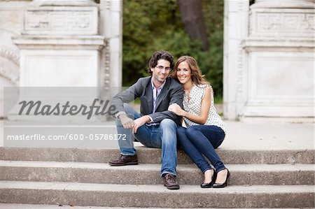 Portrait of Young Couple Sitting on Stairs in Park, Ontario, Canada