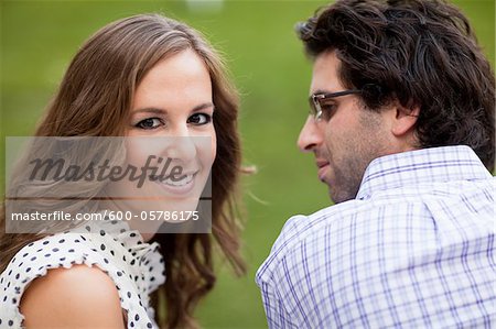 Close-up Portrait of Young Couple in Park