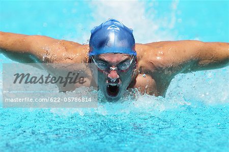 Young Man Swimming Butterfly Stroke