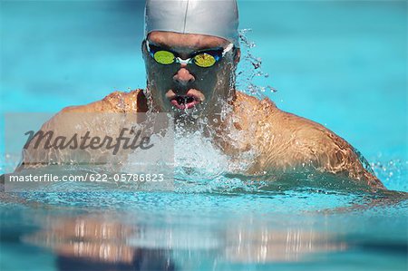 Young Man Swimming Breaststroke