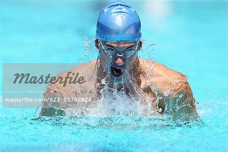 Young Man Swimming Breaststroke