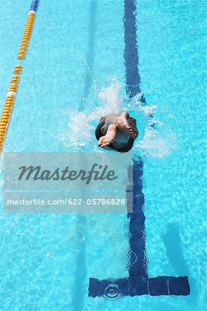 Young Man Diving into Swimming Pool
