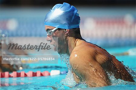 Young Man Swimming Breaststroke