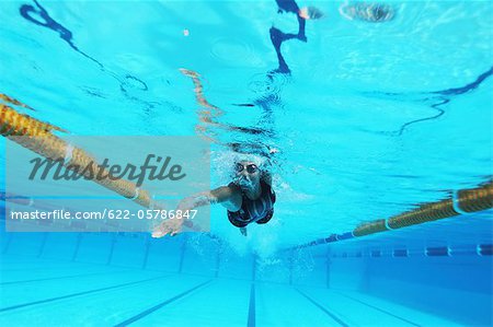 Woman Swimming in Pool, Underwater