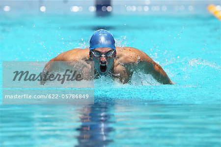 Young Man Swimming Butterfly