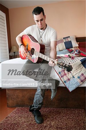 Handsome mid-adult man playing guitar