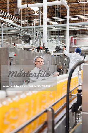 Factory men working in a bottling plant