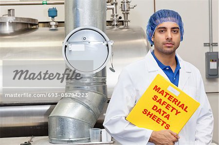 Portrait of industrial employee holding data sheets file