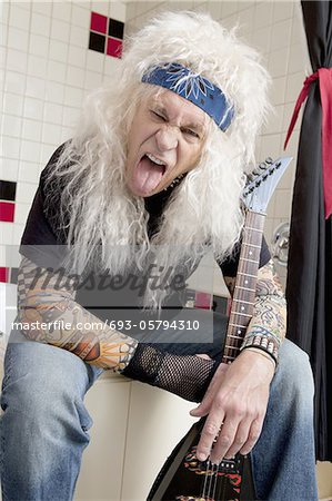 Portrait of guitarist sticking out tongue