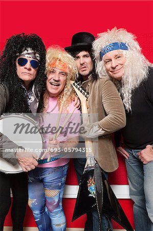 Four male friends wearing hippie clothes and posing