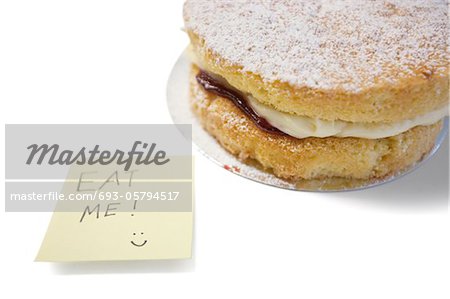 Cake slice with 'eat me' sign on sticky notepaper