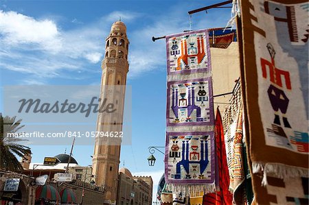 Main street with mosque and carpet shop display, Tozeur, Tunisia, North Africa, Africa