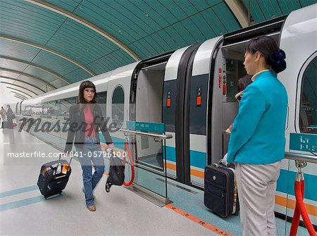Passenger boarding magnetic levitation high speed train on a Shanghai station platform, Shanghai, China, Asia