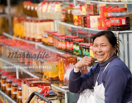 Chinese female street vendor selling packaged food and gift products, Chengdu, Sichuan, China, Asia