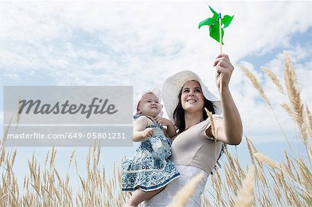 Woman holding pinwheel for daughter