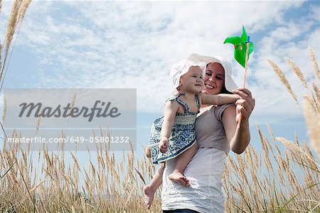 Woman holding pinwheel for daughter