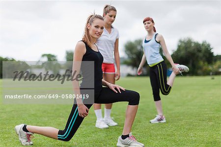 Runners stretching in park