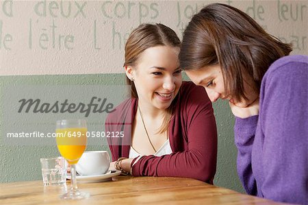 Smiling women talking in cafe
