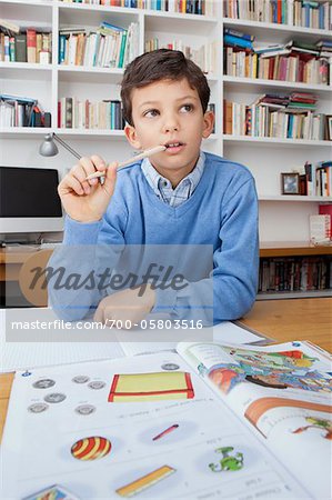 Boy Thinking While Doing Homework Boy Thinking While Doing Homework