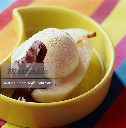 Poached pear with vanilla ice cream and chocolate sauce