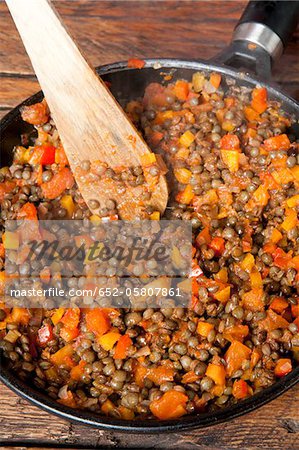 Cooking the lentils,diced tomatoes and carrots in a frying pan