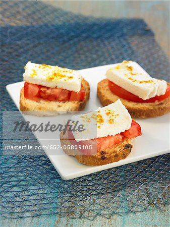 Goat's cheese,tomato and curry on toasts