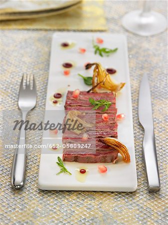 Veal carpaccio with onions and pomegrante seeds