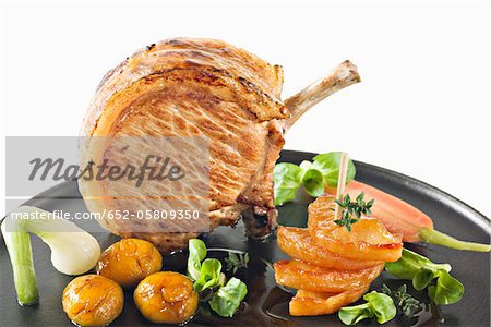 Pan-fried organic pork chops with apples,chestnuts and vegetables