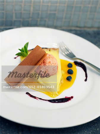 Slice of lemon tart and rose petal ice cream