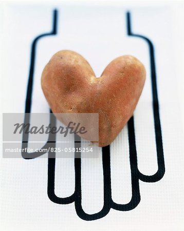 Heart-shaped potato on drawn hand