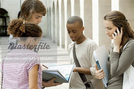 University students discussing schoolwork on campus