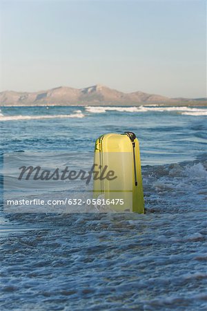 Wave breaking over suitcase