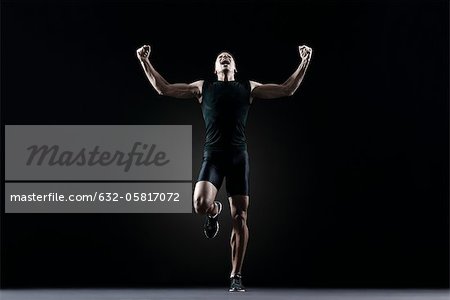 Male athlete flexing arms and shouting