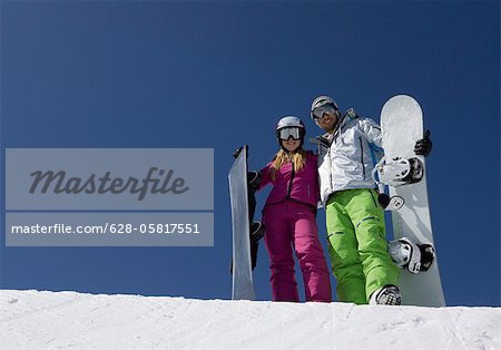 Young couple with snowboards