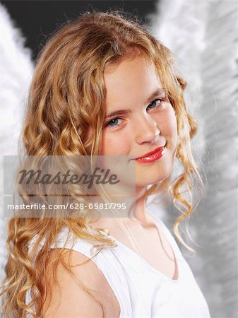 Girl with curly hair wearing angel wings