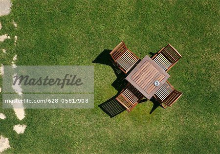 Wooden chairs and table in garden