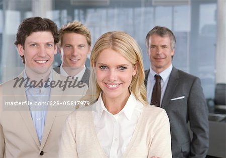 Four smiling businesspeople in office