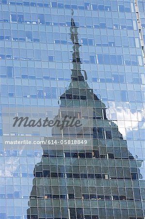 Building reflected in glass of skyscraper