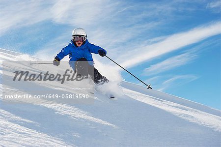 Boy skiing on snowy mountainside