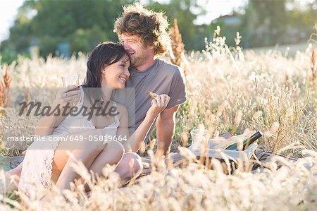 Couple picnicking in wheatfield