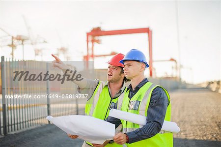 Construction workers talking on site