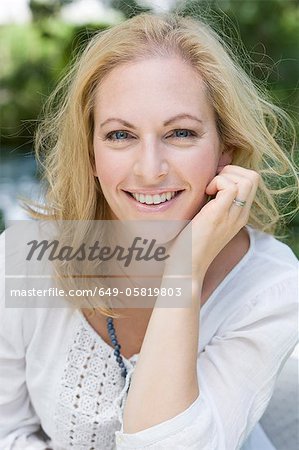 Smiling woman sitting outdoors