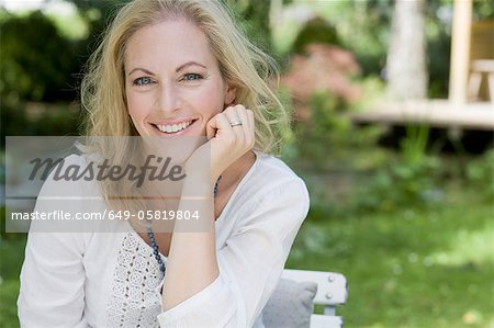 Smiling woman sitting outdoors